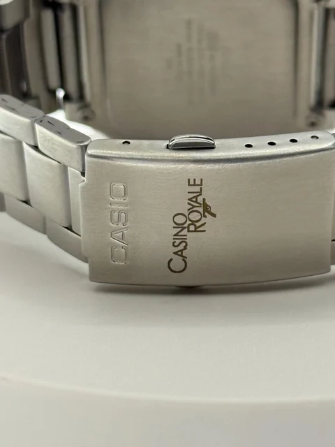 Close-up of a custom engraved design on the brushed metal clasp of a Casio watch